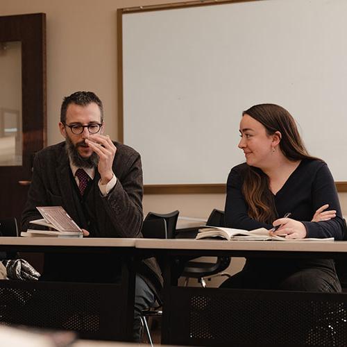 A teacher in a seminar class with a student